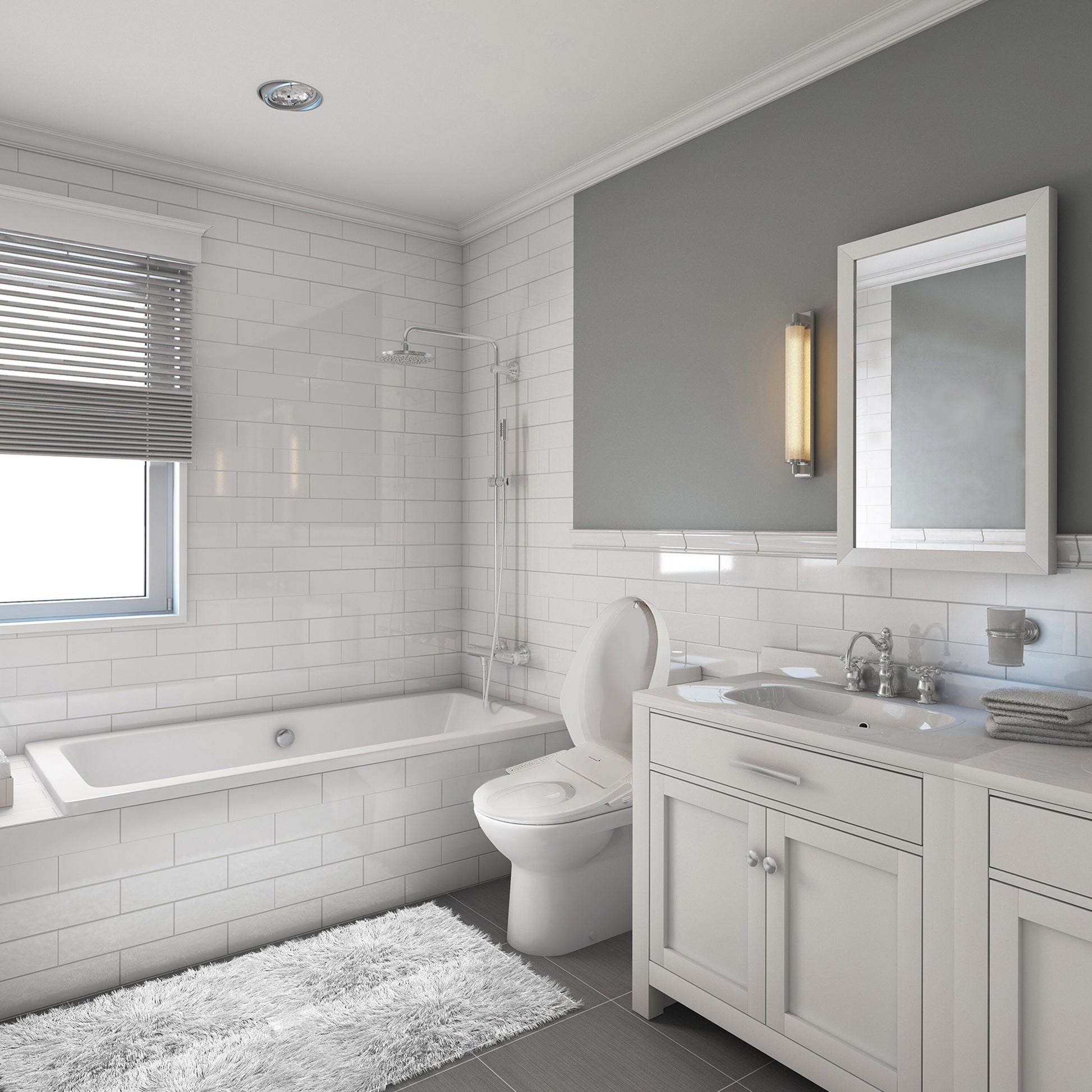 Modern bathroom with white tiles, a bathtub, toilet, and vanity.